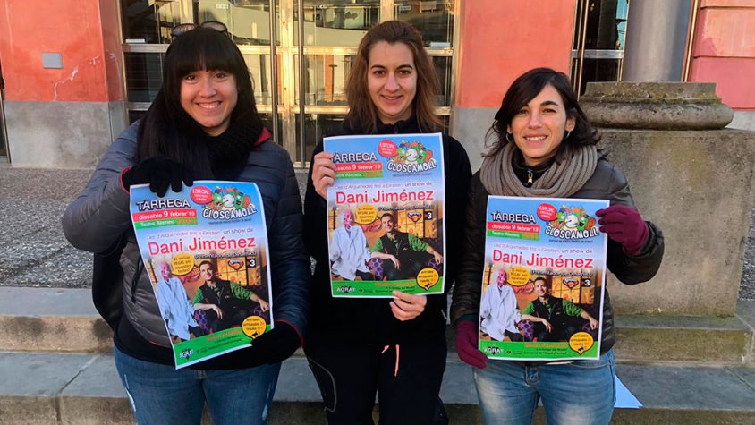 Membres de l'organització amb el cartell de l'activitat