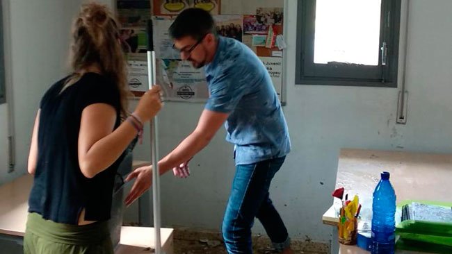 Treballadors del Grup Alba netejant les oficines inundades